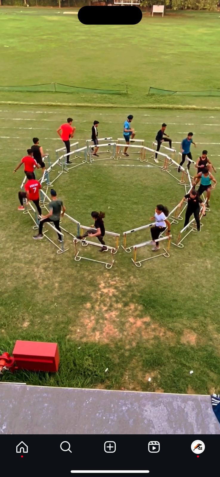 Athletes performing structured circle agility drills with hurdles at GO Speed training facility